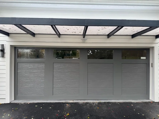Modern carriage-house garage door install Patterson NY — Reynolds