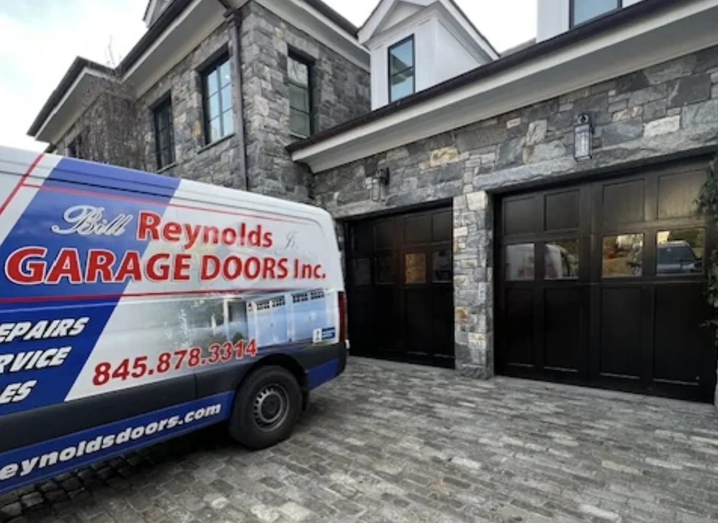 Bill Reynolds Jr. Garage Doors service van at a repair job in Brewster, NY