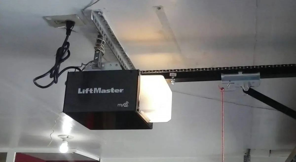 LiftMaster opener mounted to ceiling with rail and trolley — completed Reynolds installation in a Hudson Valley garage